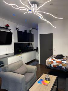 a living room with a couch and a bed at LoVe 3 avec climatisation in Cap d'Agde