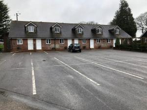 a car parked in a parking lot in front of a building at The Angel Hotel in Alton