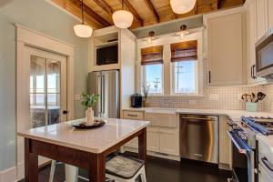 a kitchen with a table and a counter top at 4115 - Coastal Cottage in Kitty Hawk
