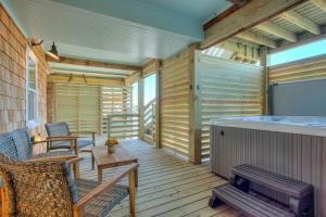 a wooden deck with a hot tub and a hot tub at 4115 - Coastal Cottage in Kitty Hawk