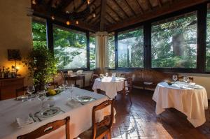 a restaurant with two tables and chairs and windows at Villa Il Paradisino in Sesto Fiorentino