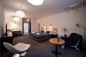 a living room with a bed and a table and chairs at Trybunalska in Lublin +33 photos