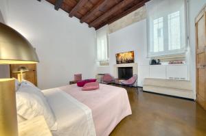 a white bedroom with a bed and a fireplace at B&B Palazzo Personè Dimora Storica in Lecce
