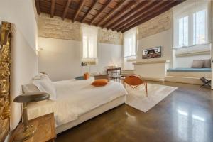 a bedroom with a large bed and a table at B&B Palazzo Personè Dimora Storica in Lecce