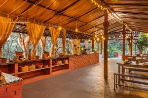 a restaurant with awnings and tables with pots at Nature Trails Rock Valley, Goa in Ponda