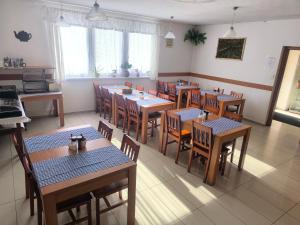 a restaurant with tables and chairs in a room at Penzion Jarka in Bratislava
