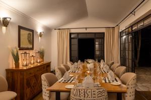 a dining room with a long table and chairs at The Maa Guest House in Talek