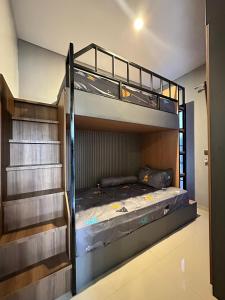 a bedroom with two bunk beds and a staircase at Athara Naya in Karangploso +100 photos