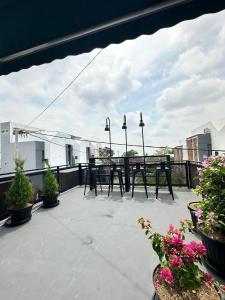 a patio with tables and chairs on a balcony at Athara Naya in Karangploso