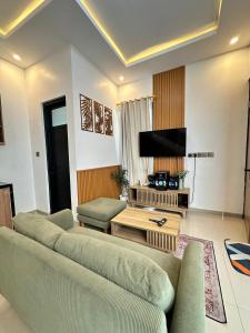 a living room with two couches and a flat screen tv at Athara Naya in Karangploso