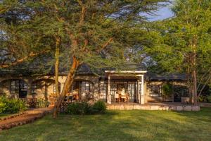 a stone house with a gambrel roof at The Maa Guest House in Talek