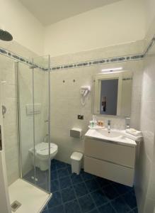 a bathroom with a toilet and a sink and a shower at Hotel SoleMare in Diano Marina +11 photos