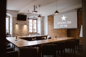 a restaurant with tables and chairs and a sign on the wall at Trybunalska in Lublin