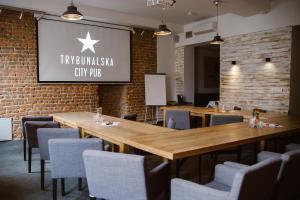 a restaurant with wooden tables and chairs and a sign at Trybunalska in Lublin