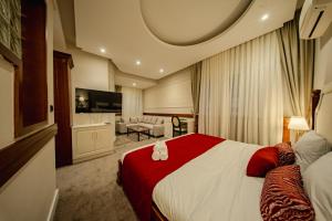 a hotel room with a bed and a living room at 49 Park Villa in Belgrade