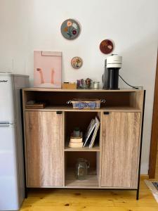 a wooden cabinet with open doors in a kitchen at Florija’s Guesthouse in Dardhë