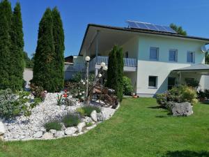 a house with a garden and some trees at Ferienwohnung Albel in Velden am Wörthersee