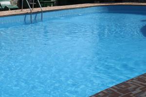 a large swimming pool with blue water at Covenant Crest Hotel in Accra