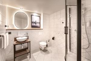 a bathroom with a shower and a sink and a toilet at Hotel Astor Kiel by Campanile in Kiel +25 photos