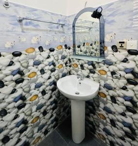 a bathroom with a sink and a mosaic wall at Yala Dream Wild Resort in Tissamaharama +41 photos