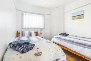 a bedroom with two beds and a window at Violet in Heacham
