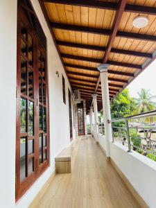 an empty hallway of a house with a wooden ceiling at Yala Dream Wild Resort in Tissamaharama