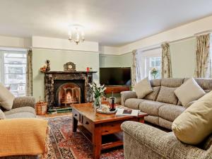 a living room with a couch and a fireplace at 4 Bed in Tavistock oc-92491 in Bulkworthy
