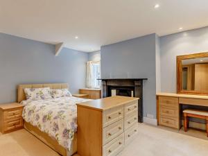 a bedroom with a bed and a desk and a mirror at 4 Bed in Tavistock oc-92491 in Bulkworthy +22 photos