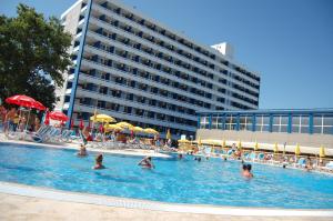 a group of people in a swimming pool in a hotel at Hotel Aurora in Mamaia