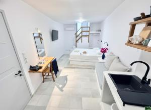 a white room with a sink and a mirror at Castellino Naxos in Naxos Chora