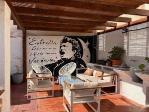 a living room with a mural of a woman at Posada de la Luna in Granada