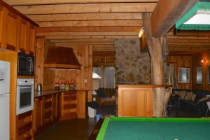 a kitchen with a pool table in a cabin at Snowdrop Lodge in Dinner Plain