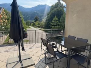 a patio with a table and chairs and an umbrella at Faraway Homes Studio Mautern #8 in Mautern in Steiermark