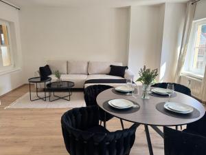 a living room with a table and chairs and a couch at Faraway Homes Studio Mautern #8 in Mautern in Steiermark +3 photos