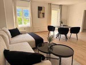 a living room with a couch and a table and chairs at Faraway Homes Studio Mautern #8 in Mautern in Steiermark