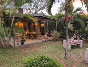 a group of people sitting outside of a house at Thelazycoco in Blue Bay