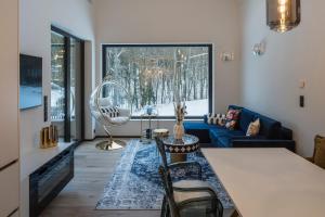 a living room with a table and a blue couch at steiRerBLiCke - Gaberhö Gamlitz in Gamlitz