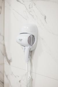 a white blow dryer hanging on a wall at готель-ресторан Дубок in Kvasy