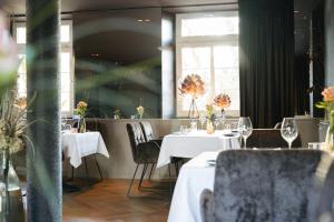a restaurant with two tables with white tablecloths at Clostermanns Hof in Niederkassel