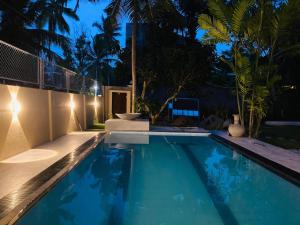 a swimming pool in a backyard at night at Thambara Villa Unawatuna in Unawatuna