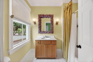 a bathroom with a sink and a mirror at EA1A: 1A Eugenia Avenue in Kiawah Island +70 photos