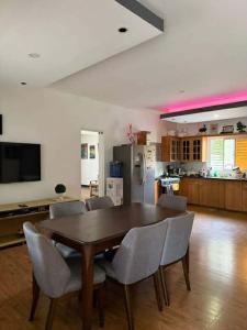 a dining room table and chairs in a kitchen at Casa Olivia in Puerto Galera