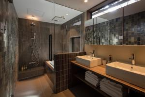 a bathroom with two sinks and a shower at Choya Goshominami Machiya House in Kyoto +27 photos