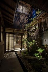 an entrance to an asian building with at Choya Goshominami Machiya House in Kyoto
