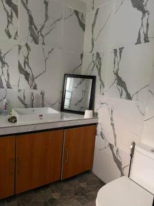 a bathroom with a sink and a toilet at Casa Olivia in Puerto Galera