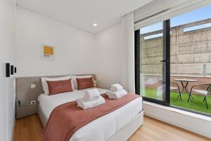 a bedroom with a bed and a large window at GuestReady - Tutti Frutti Studios in Porto +17 photos