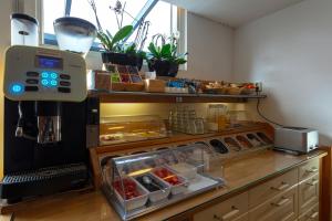 a kitchen with a counter with an oven with food at Hotel Randenbroek in Amersfoort +66 photos