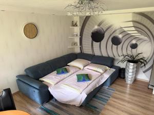 a blue couch with pillows in a living room at Apartment Rita in Hannover