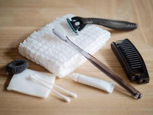 a wooden table with a hair brush and a comb at Choya Goshominami Machiya House in Kyoto