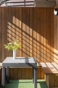 a wooden fence with a table with a plant on it at Dongdaemun Signature Tourist Hotel in Seoul